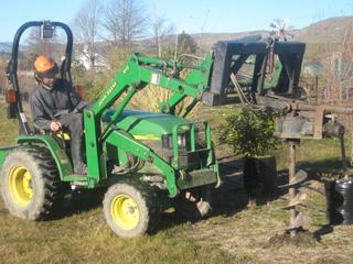 Front mounted reversable auger
